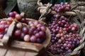 Various bunches of red grapes on wicker basket