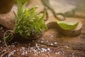 Various bundles of fresh herbs on a wooden background