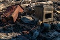 Various burnt things after the fire are scattered on the ground. A destroyed private house after being hit by an artillery shell.