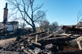 Various burnt things after the fire are scattered on the ground. A destroyed private house after being hit by an artillery shell.