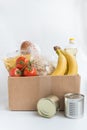 Various canned food in the carton box  on a table  with copy space Royalty Free Stock Photo