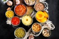 Canned vegetables, beans, fish and fruits in tin cans on black background. Food stocks Royalty Free Stock Photo