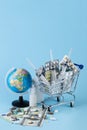 Various capsules, tablets and medicine in shop trolley with geographic globe