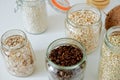 Various cereals, coffee, nuts, bran in glass jars.