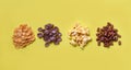 Various cereals cornflakes snack and popcorn pile on yellow background top view for breakfast Royalty Free Stock Photo