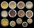 Various cereals, seeds, beans, peas on plates isolated on black background, top view. Royalty Free Stock Photo