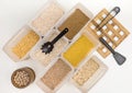 Various cereals - wheat, peas, buckwheat, millet, oatmeal, barley out of focus in open plastic containers for bulk products and Royalty Free Stock Photo