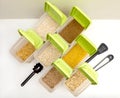 Various cereals - wheat, peas, buckwheat, millet, oatmeal, barley out of focus in open plastic containers with green lids for bulk Royalty Free Stock Photo