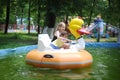 Diverse children - a little boy and a teenage girl riding a water attraction in the park Royalty Free Stock Photo