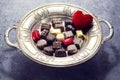 Various chocolate on antique silver plate for valentine`s day Royalty Free Stock Photo