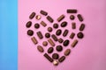 Various chocolate candies isolated on pink background. Saint Valentines day concept Royalty Free Stock Photo