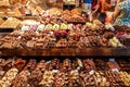 Various chocolate desserts for sale at a shop in the La Boqueria market.