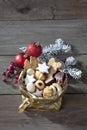 Various Christmas cookies in golden sacket on wooden background