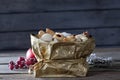 Various Christmas cookies in golden sacket on wooden background