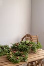 Various christmas wreathes on wooden table in home interior