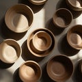 Various clay bowls arranged on a light surface, casting soft shadows. The bowls vary i Royalty Free Stock Photo