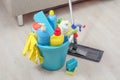 Various cleaning products with gloves in a blue bucket in the room. The concept of cleaning in the house, in the apartment Royalty Free Stock Photo