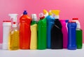 Various cleaning supplies, detergents and cleaning products on pink background Royalty Free Stock Photo