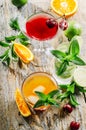 Various cocktail beverages mix with fruit and alcohol on wooden table from above. Tropical juice drink with orange, lime, cherry Royalty Free Stock Photo