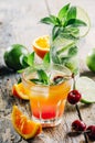 Various cocktail beverages mix with fruit and alcohol on wooden table from above. Tropical juice drink with orange, lime, cherry Royalty Free Stock Photo