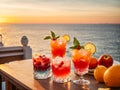 Various cocktails, sea view, sunset juice glasses fruit berries citrus