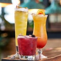 Various cocktails in tall glasses with lemon, blackberry and passion slices on top Royalty Free Stock Photo