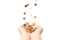 Various coins falling into a persons hands isolated on a white background