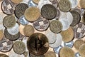 Various coins piled with bitcoin cryptocurrency