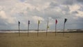 Various color of flags on wooden poles at the Batu Burok Beach Royalty Free Stock Photo