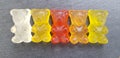 Various colored gummy bears in a row