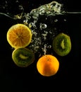 Various colorfu fruits orange, lemon and kiwi splash of water on Royalty Free Stock Photo
