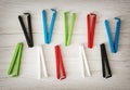 Various colorful bag clips on the wooden background Royalty Free Stock Photo