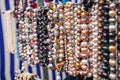 Various colorful beads in the market. Wallpaper background of a colorful necklace made of precious stones and colored Royalty Free Stock Photo