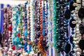 Various colorful beads in the market. Wallpaper background of a colorful necklace made of precious stones and colored beads. Royalty Free Stock Photo