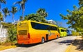 Various colorful buses tour bus transport in Puerto Escondido Mexico