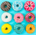 Various colorful donuts on blue background. Royalty Free Stock Photo