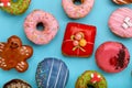 Various colorful donuts on blue background. Top view. Royalty Free Stock Photo