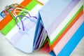 Various colorful empty gift paper bags stacked