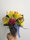 Various Colorful Flowers In A Glass Flowerpot With Ribbon