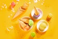 Various colorful ice cream scoops or balls with waffle cones on yellow background. Top view Royalty Free Stock Photo