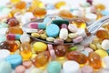 Various colorful medicine drugs on spoon. Royalty Free Stock Photo