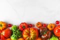 Various colorful organic tomatoes on white background. food composition. flat lay Royalty Free Stock Photo