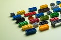 various colorful plastic toy bricks stackable blocks on yellow panoramic background, childhood education construction concept Royalty Free Stock Photo