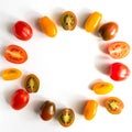 Various colorful tomatoes isolated on white background. Vegetable frame with copy spcace. Top view, flat lay. Creative layout