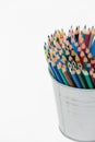 Various colour pencils organized in a can. Stack of colored pencils in a tin can on white background Royalty Free Stock Photo