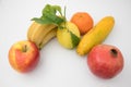 Various brightly coloured fruits against isolated white background.