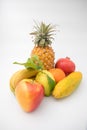 Various brightly coloured fruits against isolated white background.