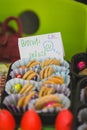 Various colourful biscuits in paper and trays, handwritten tag by kids, Romanian