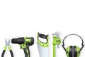 Various construction tools including drill, saw, wrench, pliers, and earmuffs isolated on white background, concept of hardware Royalty Free Stock Photo
