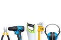 Various construction tools including drill, saw, wrench, pliers, and earmuffs isolated on white background, concept of hardware Royalty Free Stock Photo